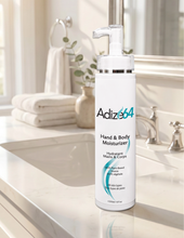 Load image into Gallery viewer, Adize64 Hand & Body Moisturizer 250 ml bottle on a bathroom counter.